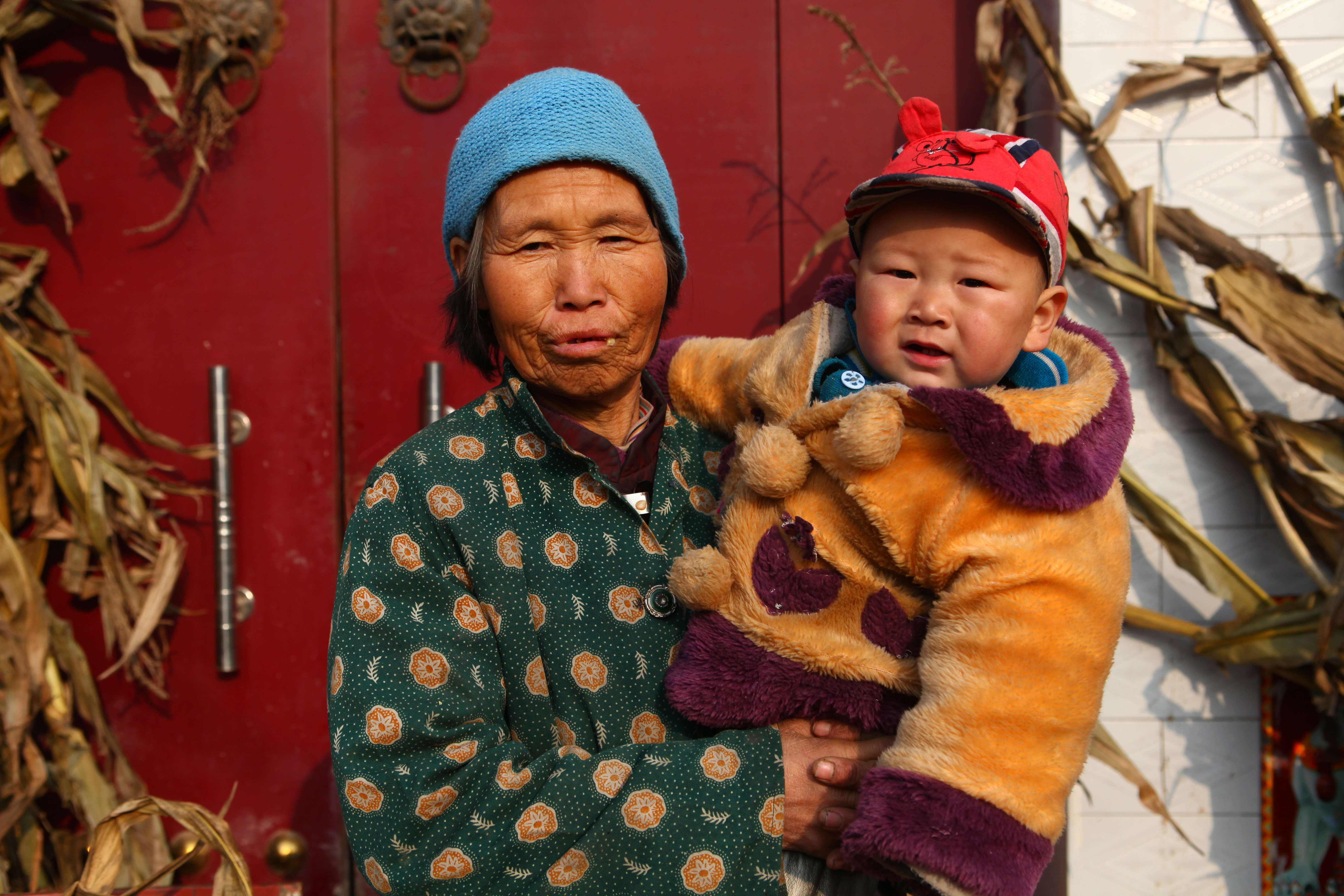 A grandma in China holds her grandchild.
