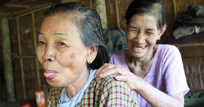An older woman receives home based care in Myanmar. 