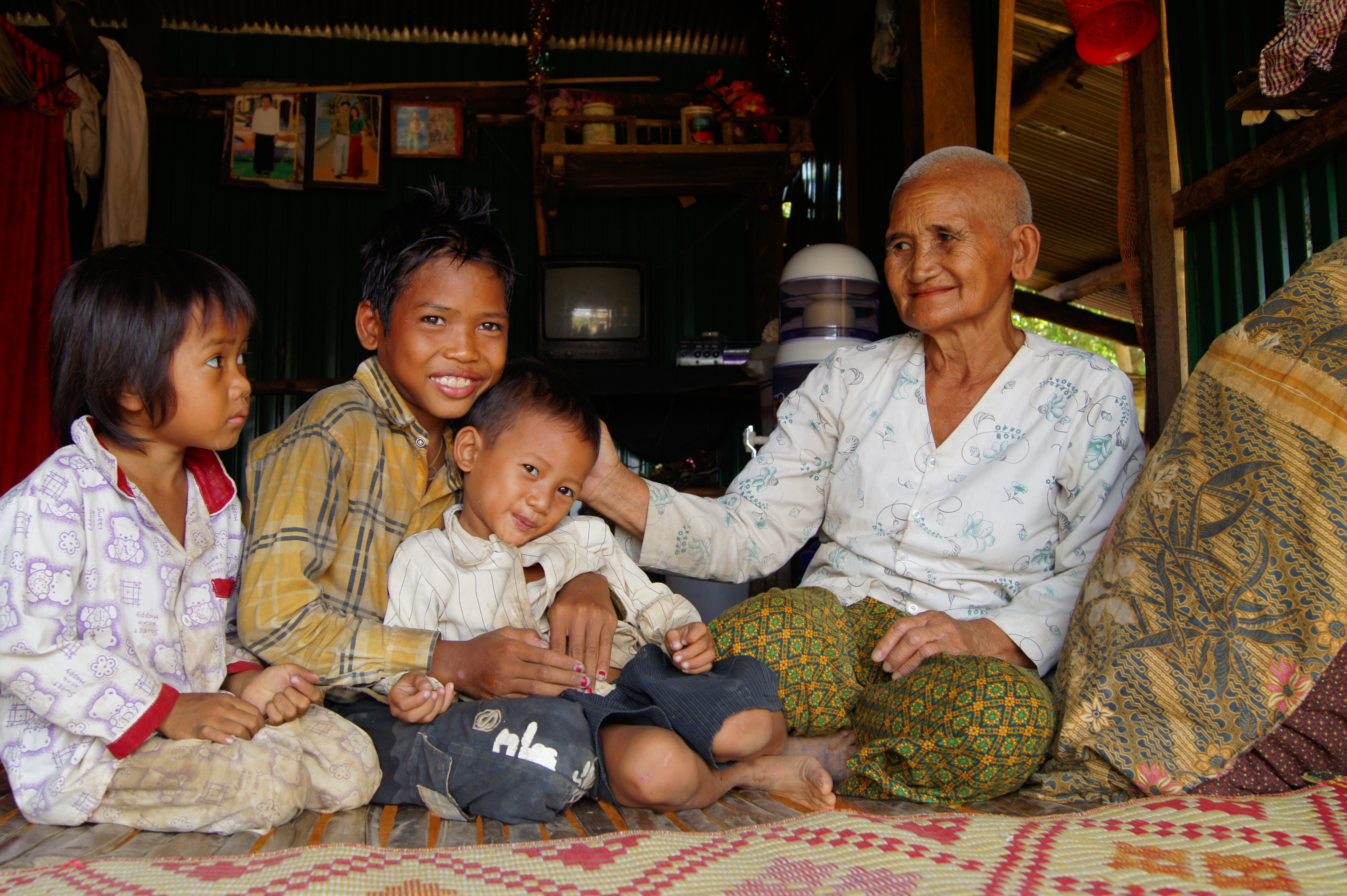 An older woman in Cambodia with her three grandchildren.