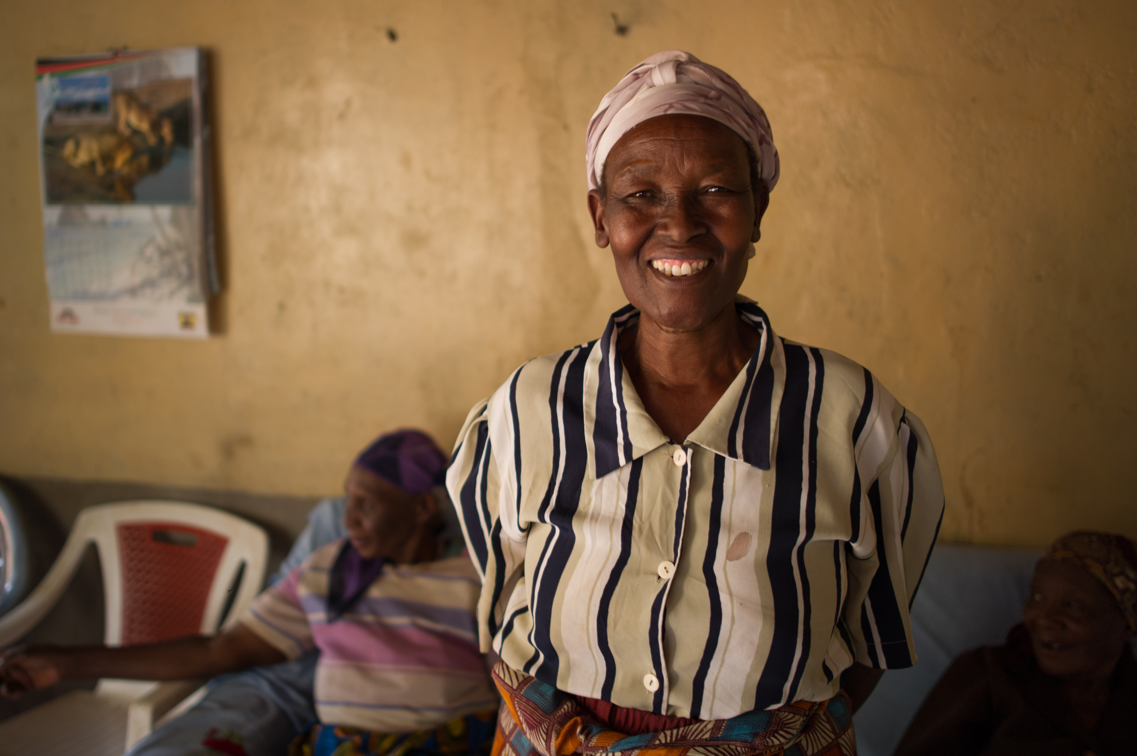 Anne, 65, from Kenya smiles widely. 