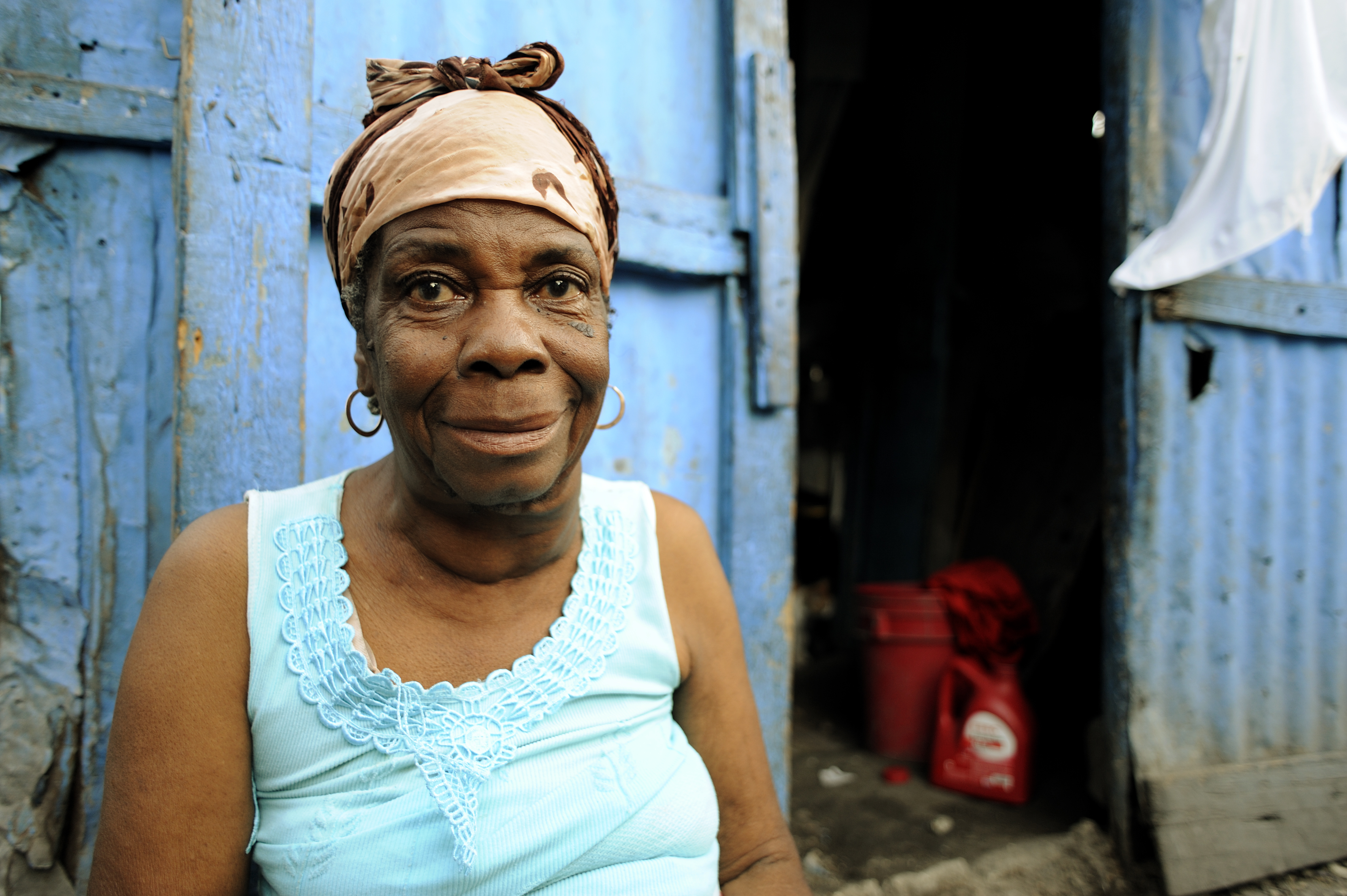 An older woman in Haiti smiles.