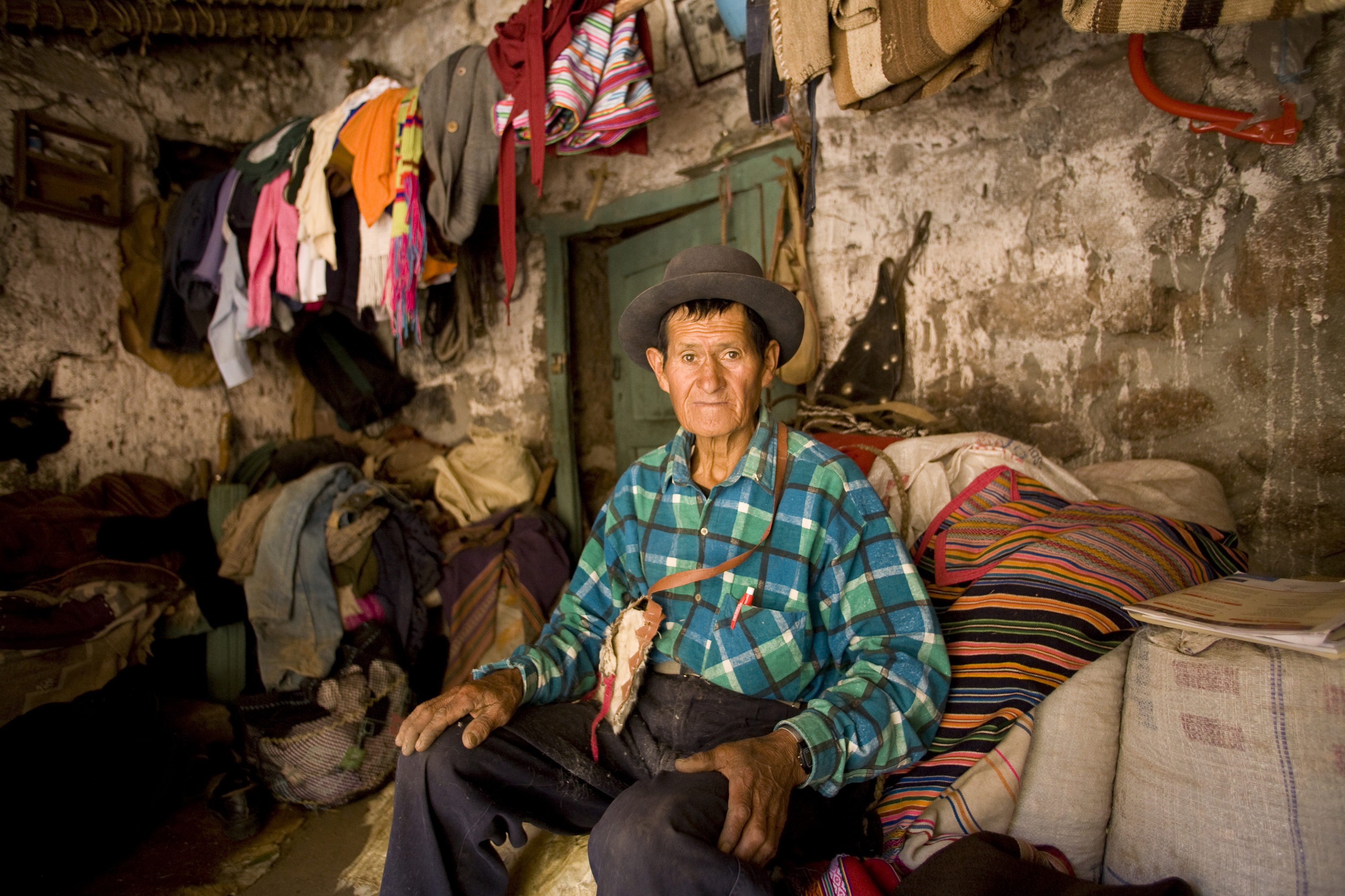 An older man sits in his house in Peru.